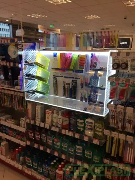 Special illuminated display stand integrated into shelf in retail spaces.